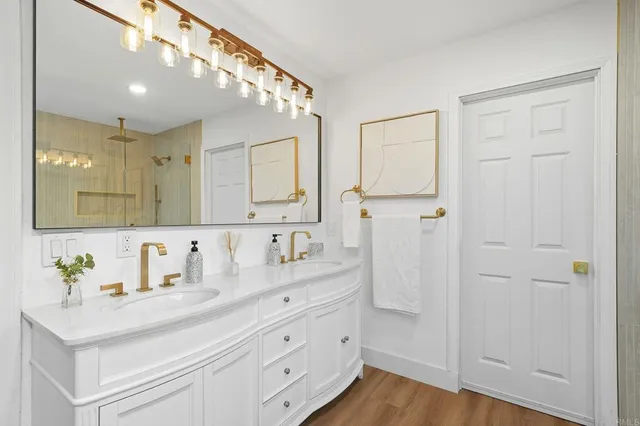 a living room with a bed furniture and a wooden floor