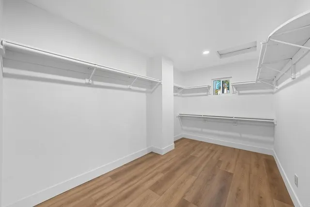 a bathroom with a granite countertop sink toilet and mirror