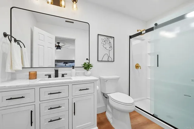 a view of a chairs and table in the back yard of the house