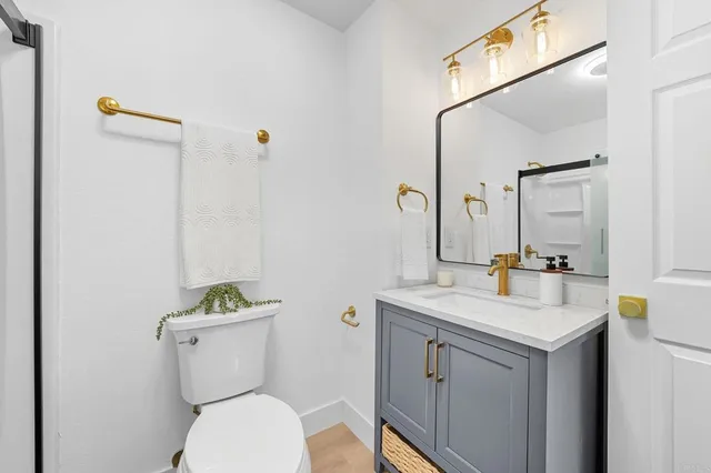 a view of a swimming pool with a chairs and palm trees