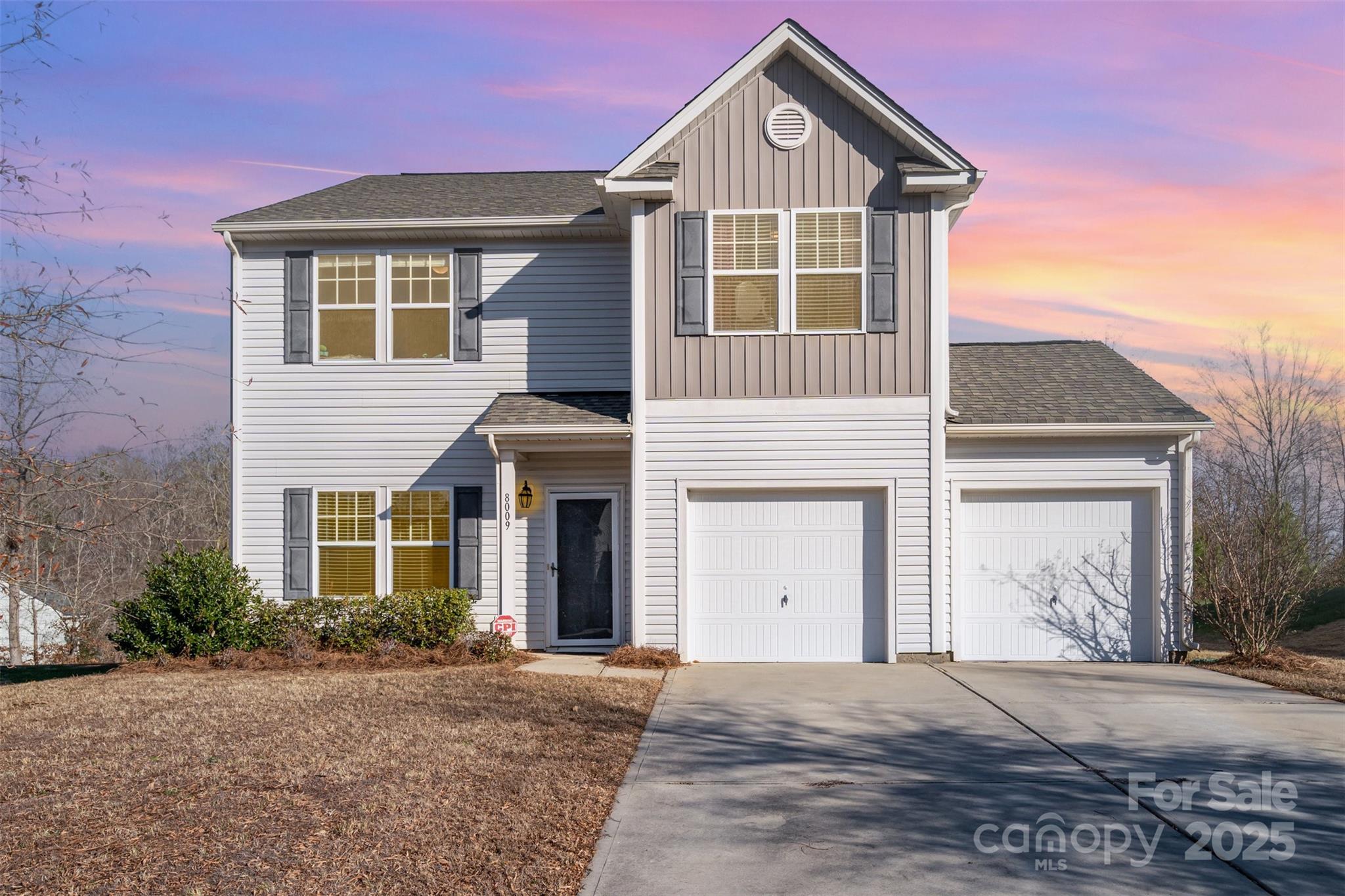 8009 Camden Crossing Lowell, NC 28098 - Photo 2 of 20 a front view of a house with a yard and garage