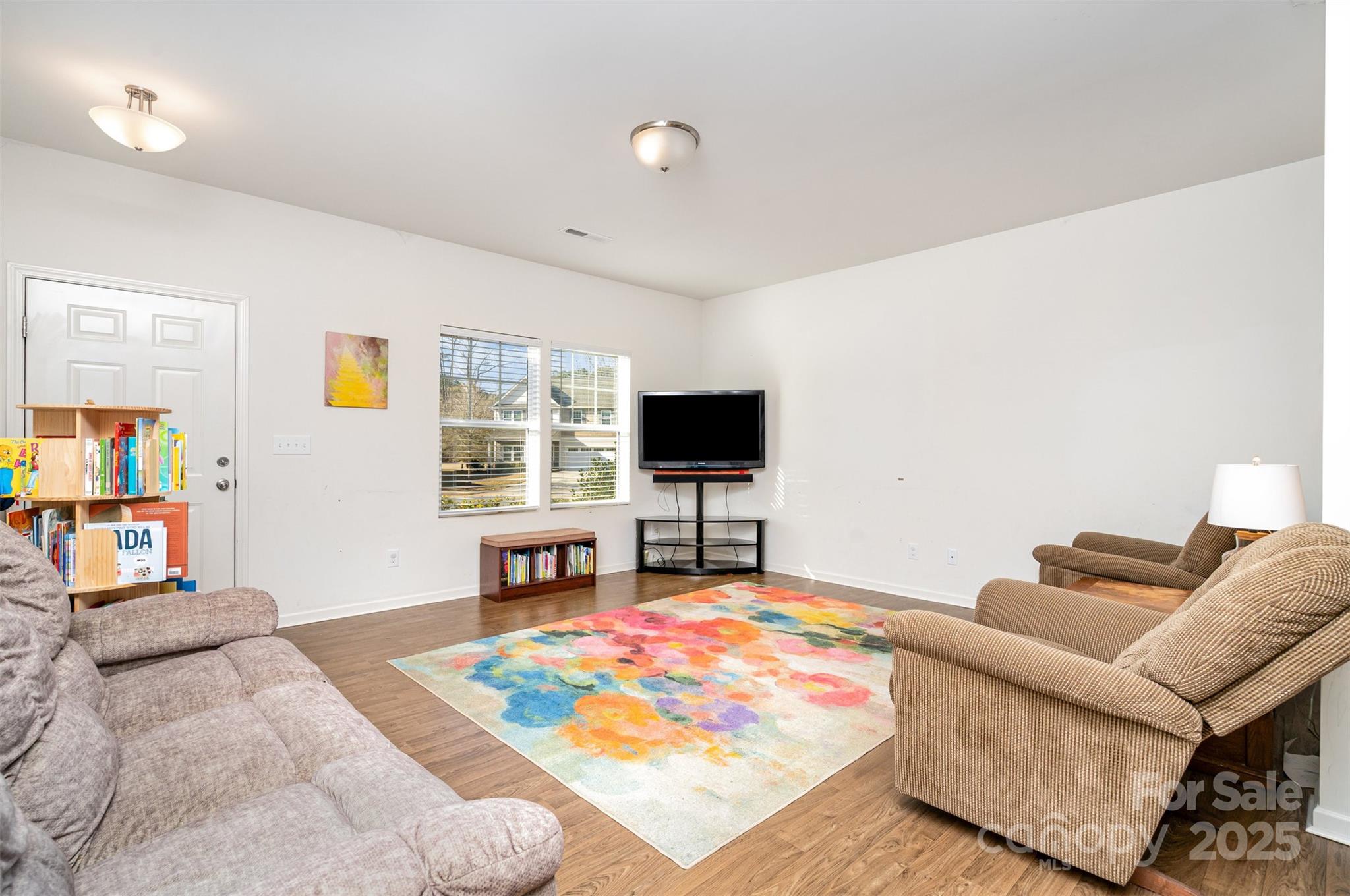 8009 Camden Crossing Lowell, NC 28098 - Photo 4 of 20 a living room with furniture and a flat screen tv