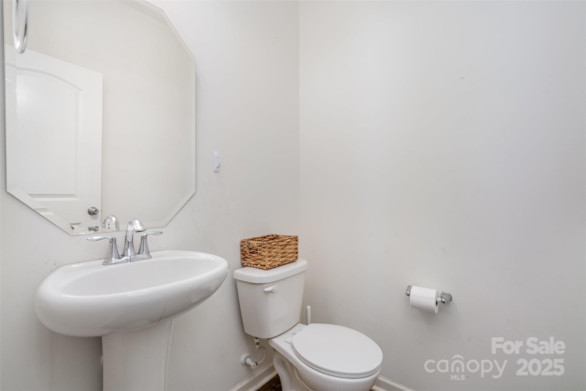 8009 Camden Crossing Lowell, NC 28098 - Photo 8 of 20 a bathroom with a sink a toilet and a mirror
