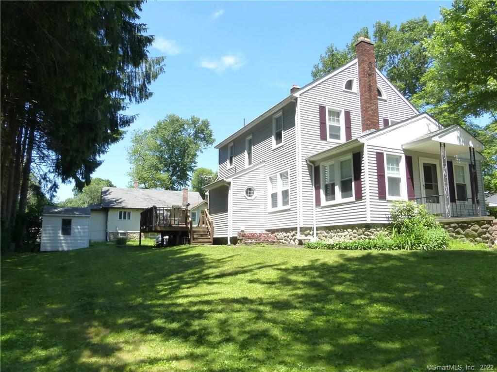 1575 Meriden Road Wolcott, CT 06716 - Photo 1 of 1 a front view of a house with a yard table and chairs