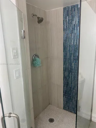 a bathroom with a sink and shower