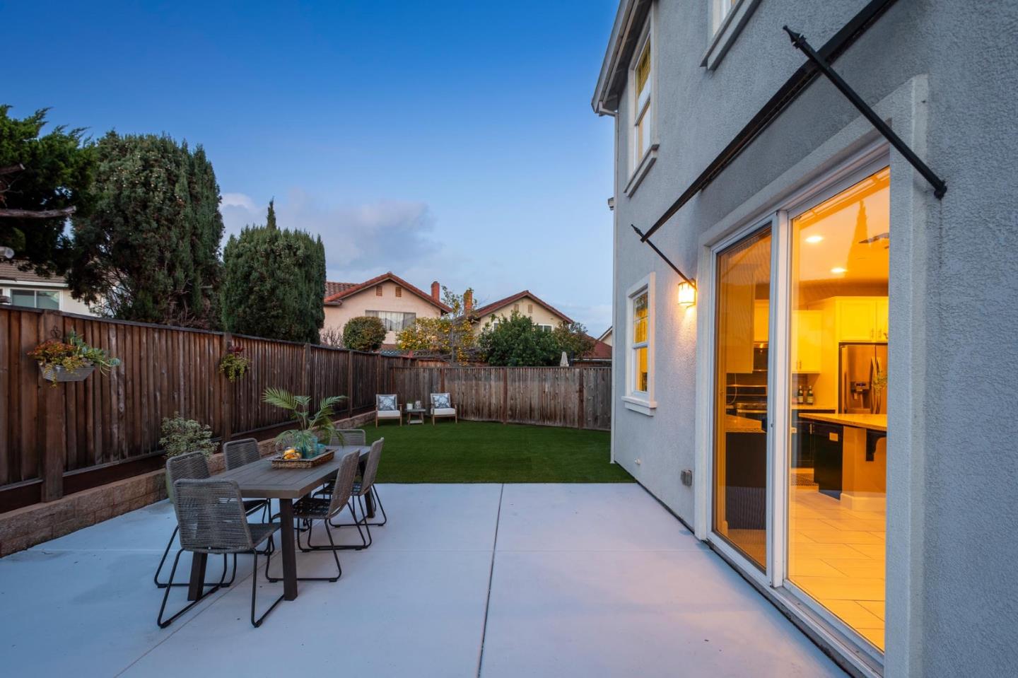 24252 Nora Circle Hayward, CA 94545 - Photo 34 of 51 a view of a patio with table and chairs potted plants with wooden floor and fence