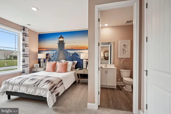 a bedroom with a bed and a view of living room