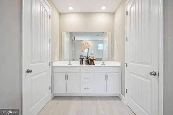 a bathroom with a double vanity sink and mirror