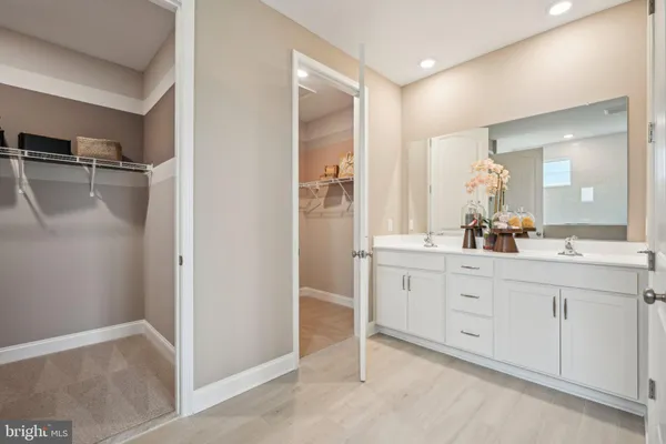 a spacious bathroom with a shower sink and mirror