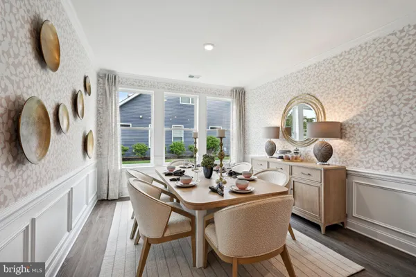 a dining room with furniture and wooden floor