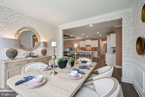 a dining room with furniture and a wooden floor