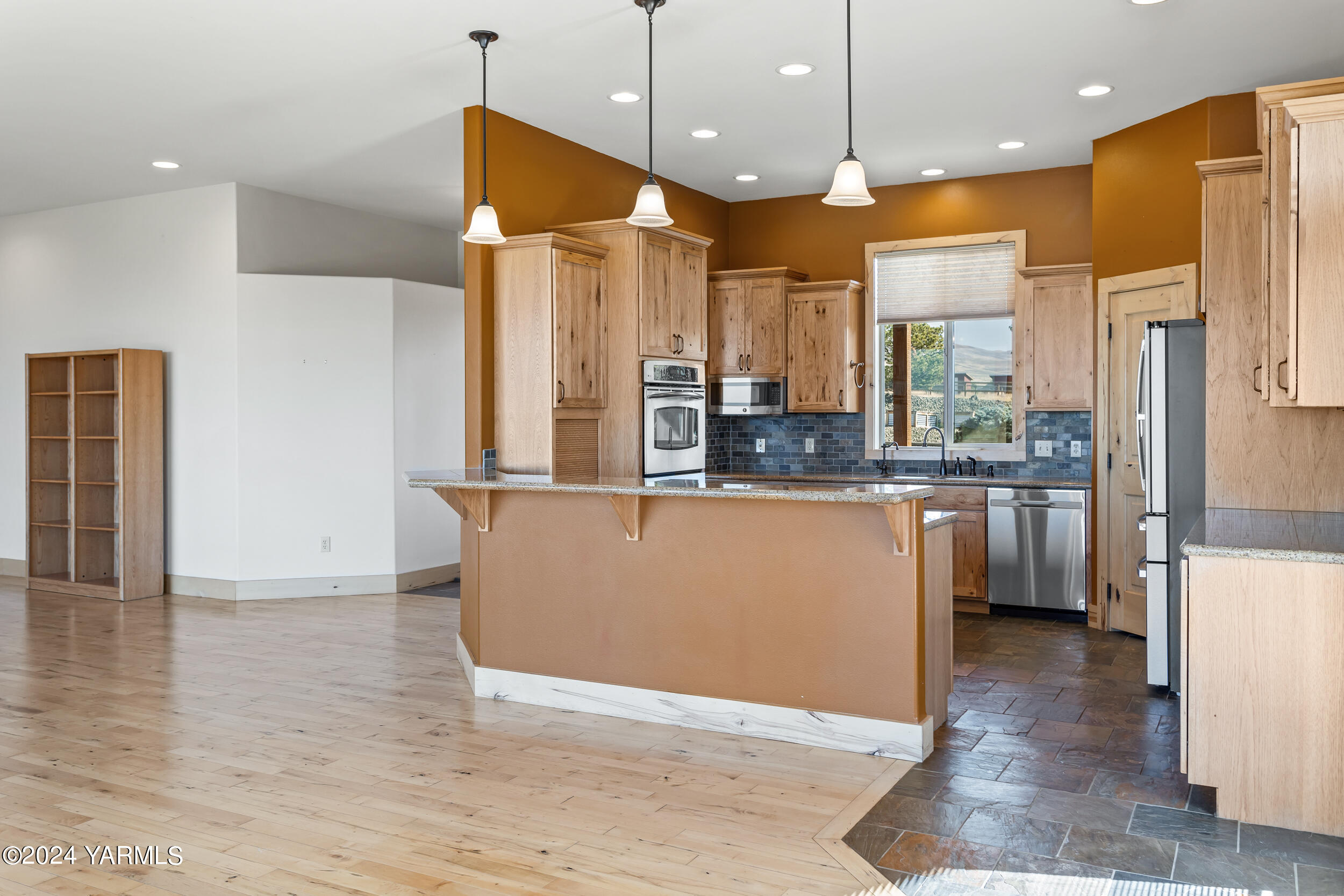 950 St Hilaire Road Yakima, WA 98901 - Photo 9 of 55 a kitchen with stainless steel appliances granite countertop a refrigerator a sink and a stove