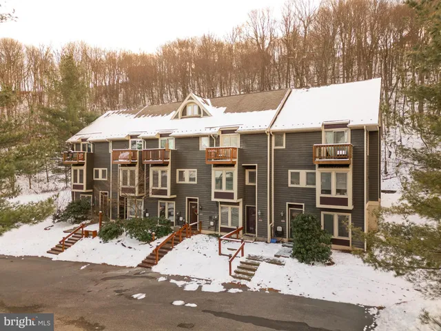 a view of a white house with a sink and yard in the background