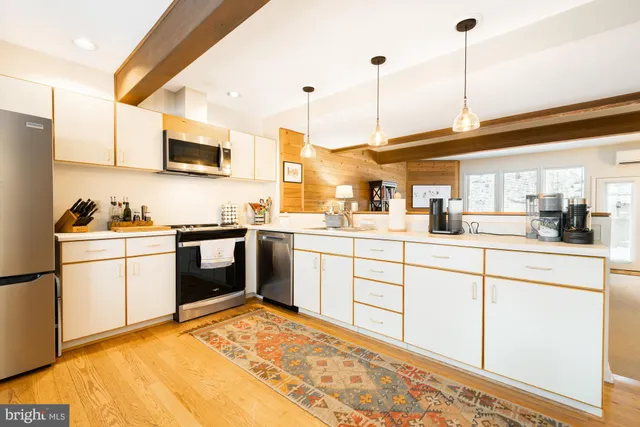 a kitchen with stainless steel appliances a refrigerator and a stove top oven