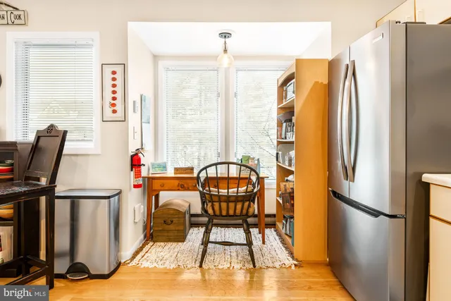 a view of a dining room with furniture and a window