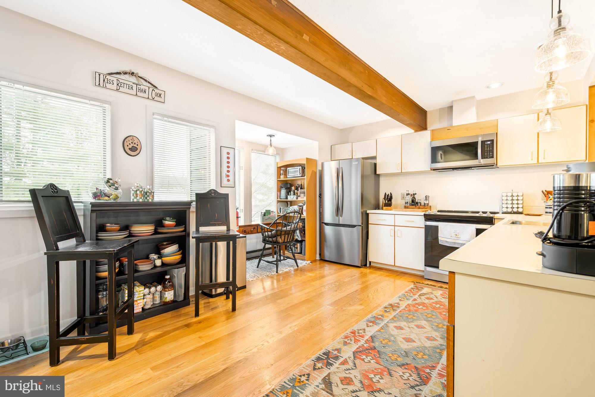 6 Winding Way, Unit 19C McHenry, MD 21541 - Photo 18 of 62 a kitchen with stainless steel appliances kitchen island granite countertop a table chairs and a refrigerator