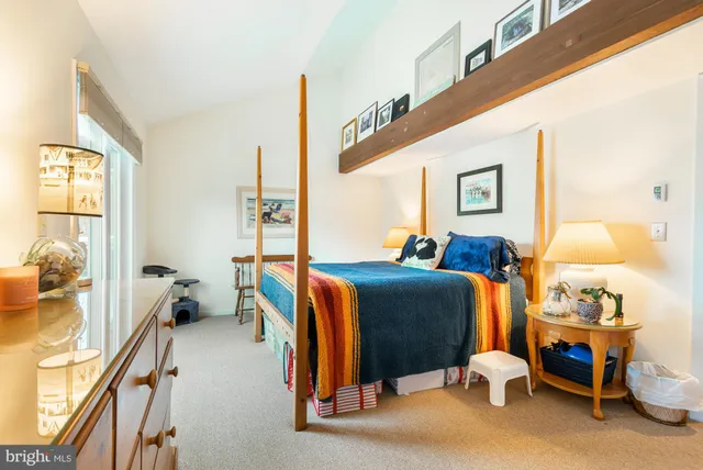 a bedroom with furniture and a flat screen tv