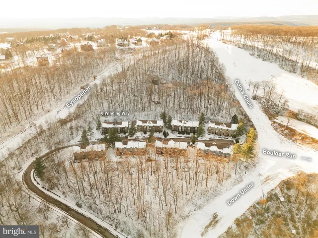 a front view of a residential apartment building with a yard