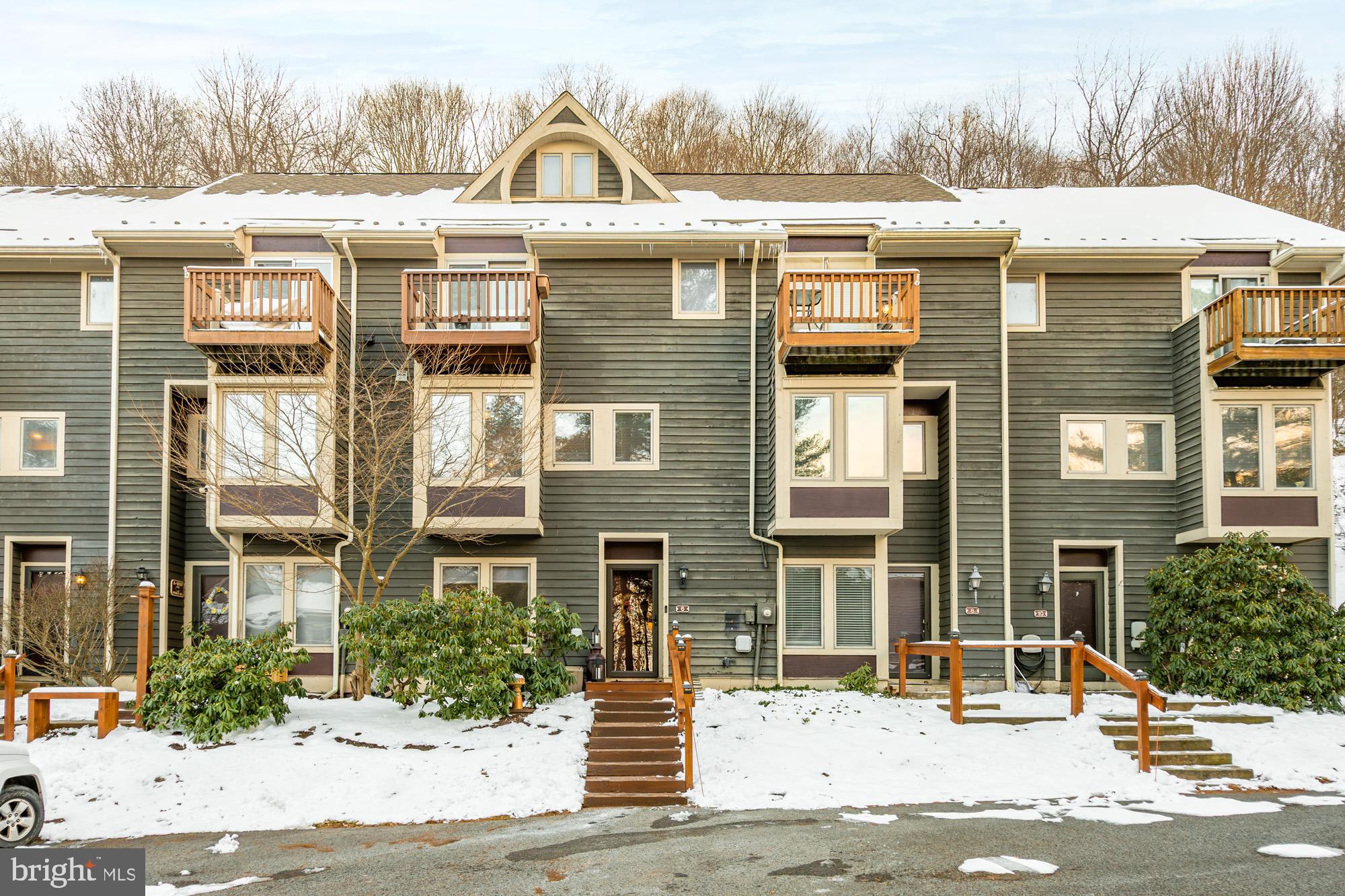 6 Winding Way, Unit 19C McHenry, MD 21541 - Photo 4 of 62 a front view of a residential apartment building with a yard