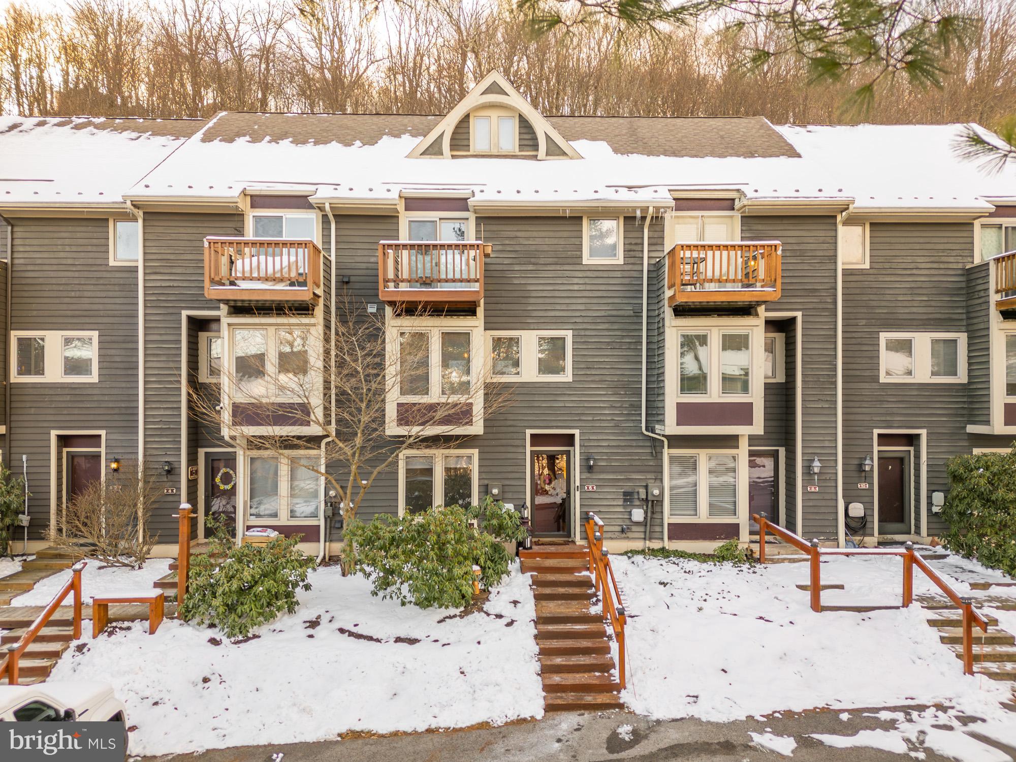 6 Winding Way, Unit 19C McHenry, MD 21541 - Photo 6 of 62 a view of a brick house with many windows