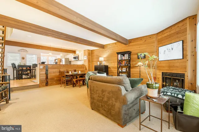 a living room with furniture a flat screen tv and a table