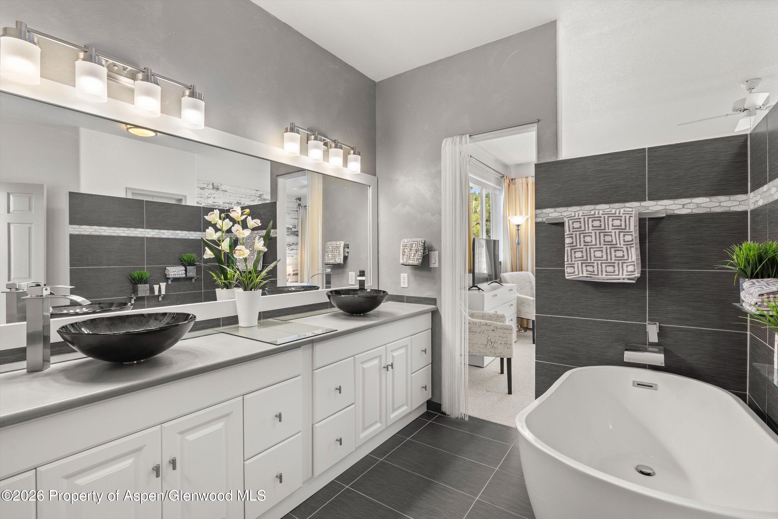 1 Pine Ridge Road Basalt, CO 81621 - Photo 17 of 32 a bathroom with a tub sink and mirror