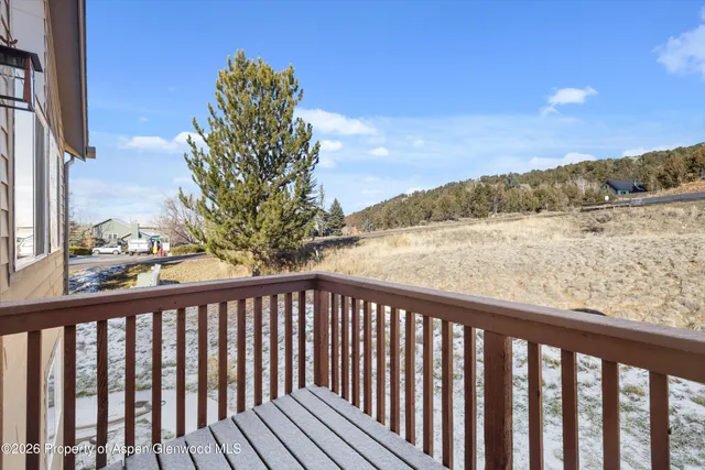a view of a balcony with wooden fence and floor