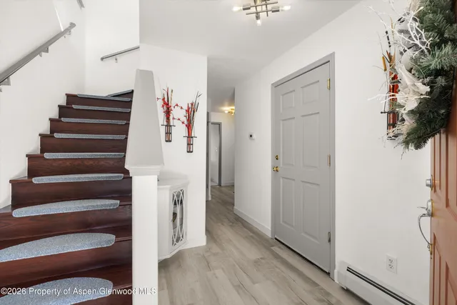 a view of entryway with stairs and wooden floor