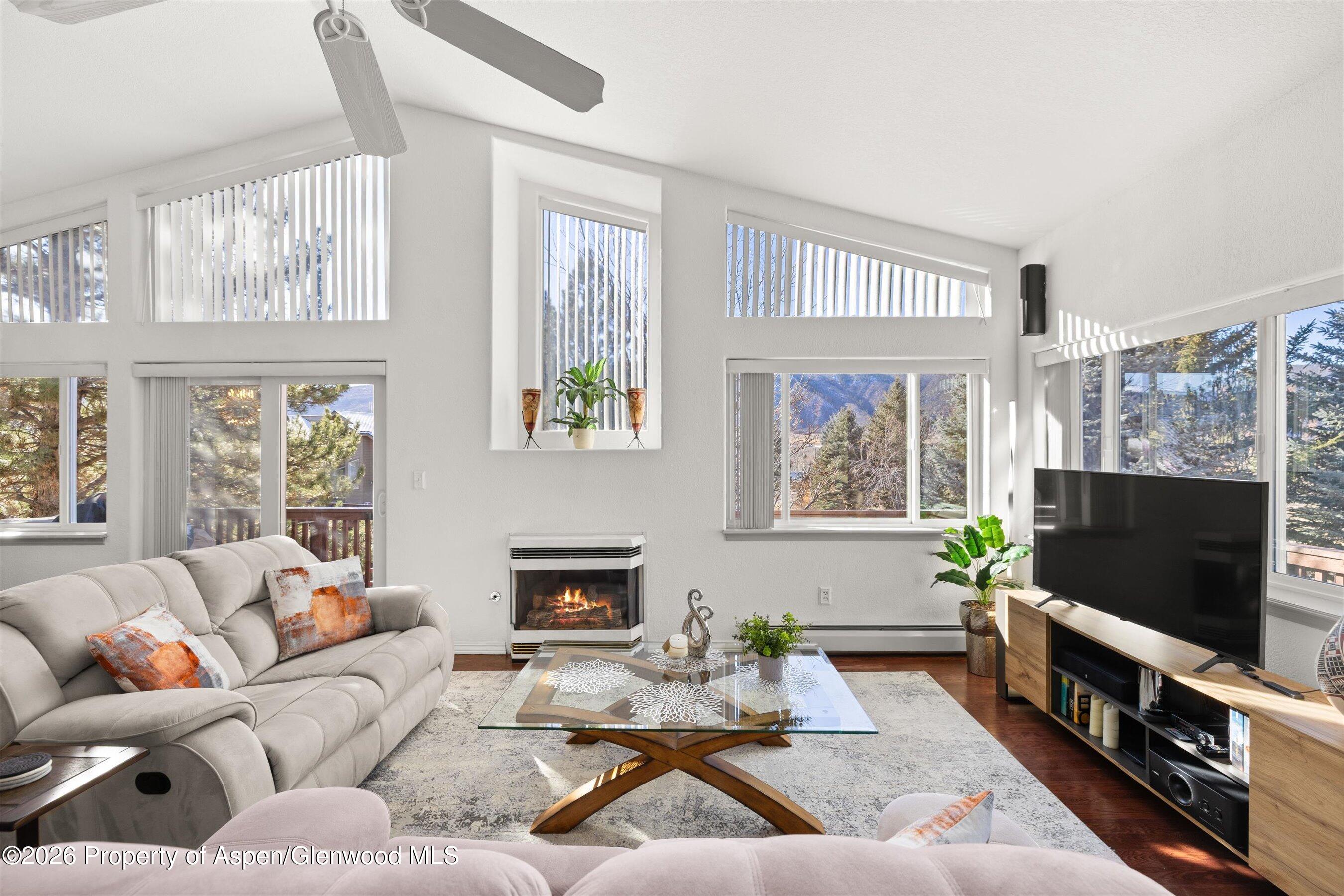 1 Pine Ridge Road Basalt, CO 81621 - Photo 4 of 32 a living room with furniture a flat screen tv and a fireplace