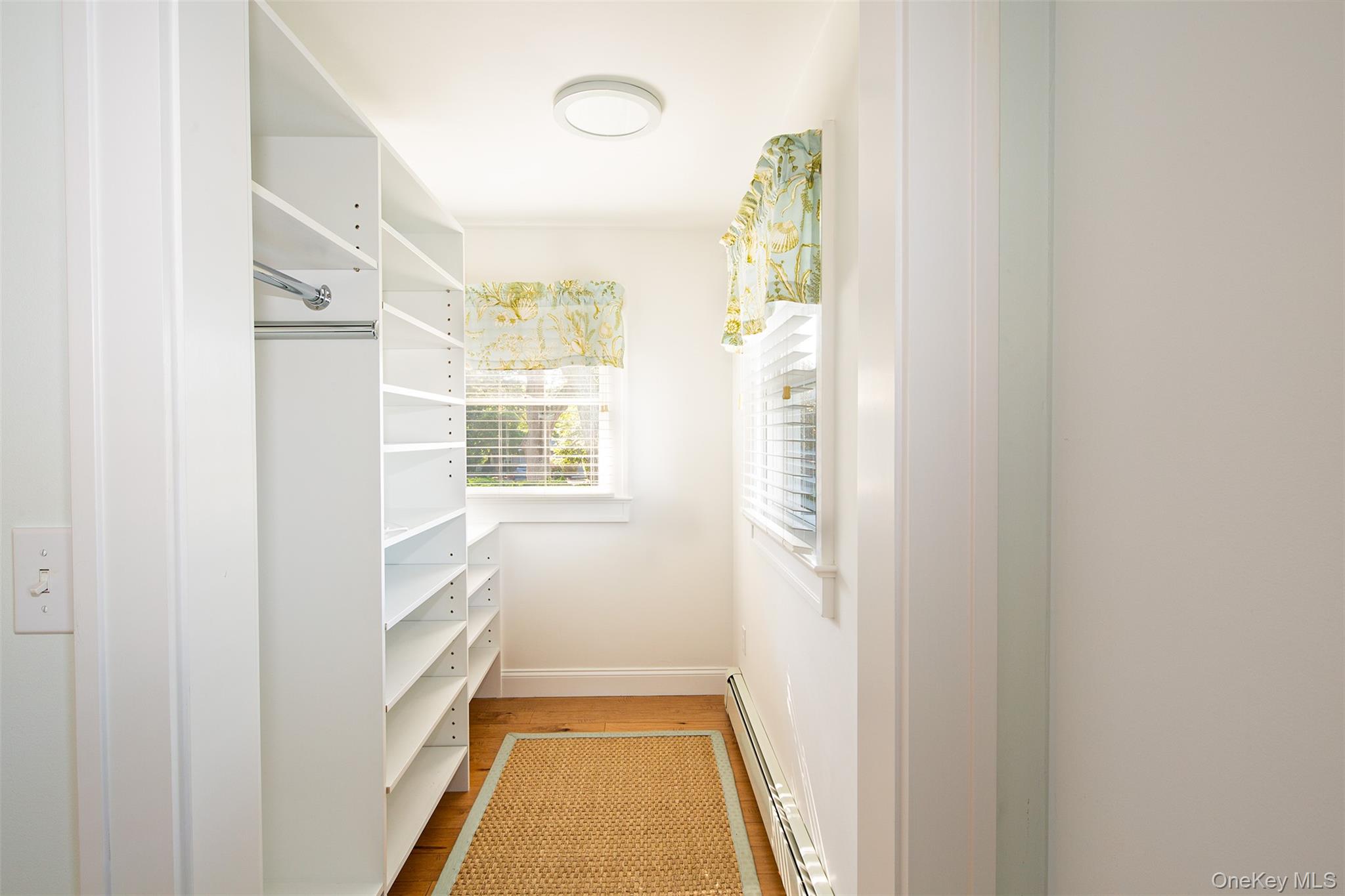 1 Canal Road Hampton Bays, NY 11946 - Photo 31 of 50 Walk in closet featuring light wood finished floors and baseboard heating