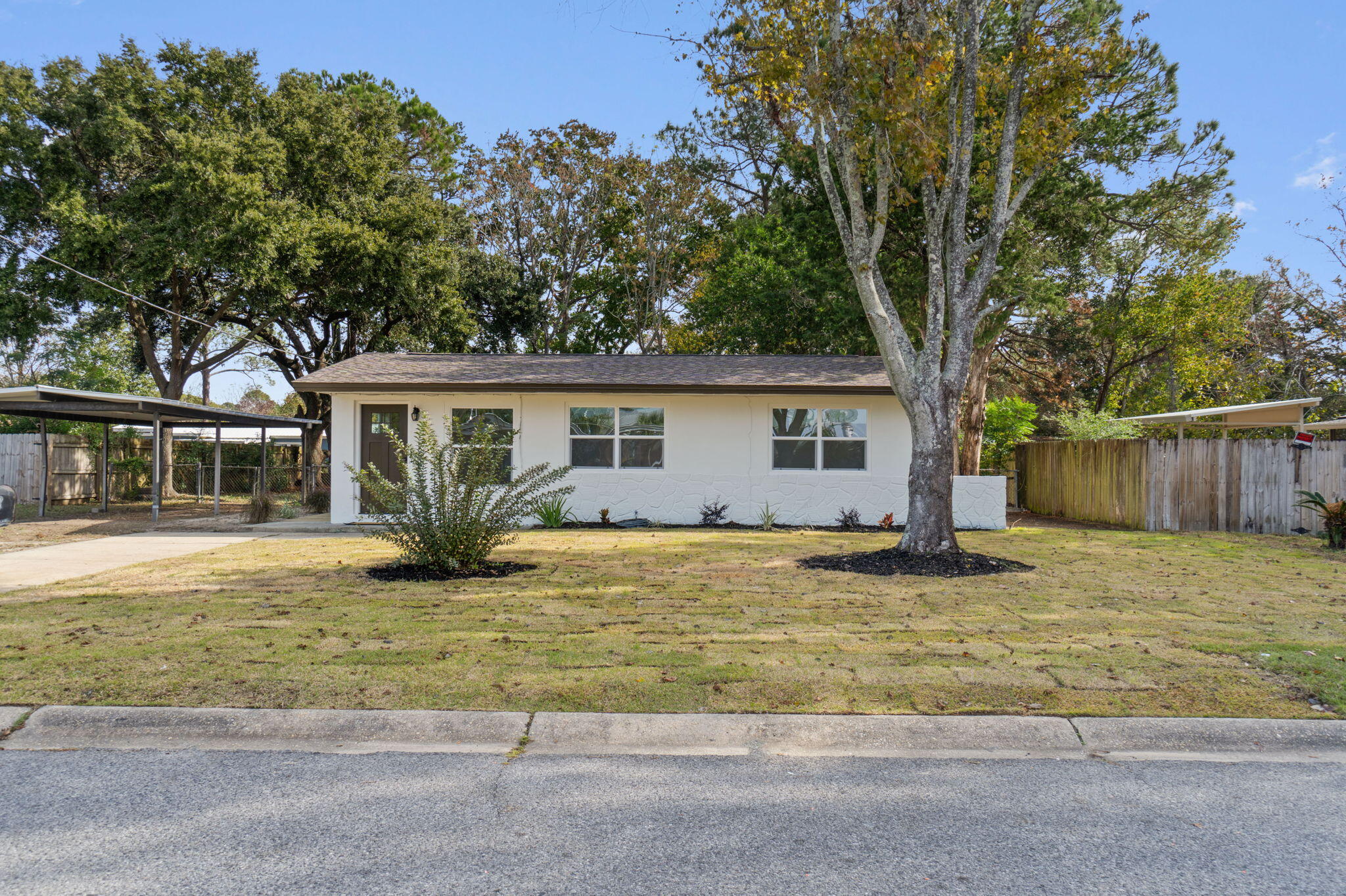 630 Shrewsbury Road Mary Esther, FL 32569 - Photo 2 of 39 a front view of house with yard and trees around
