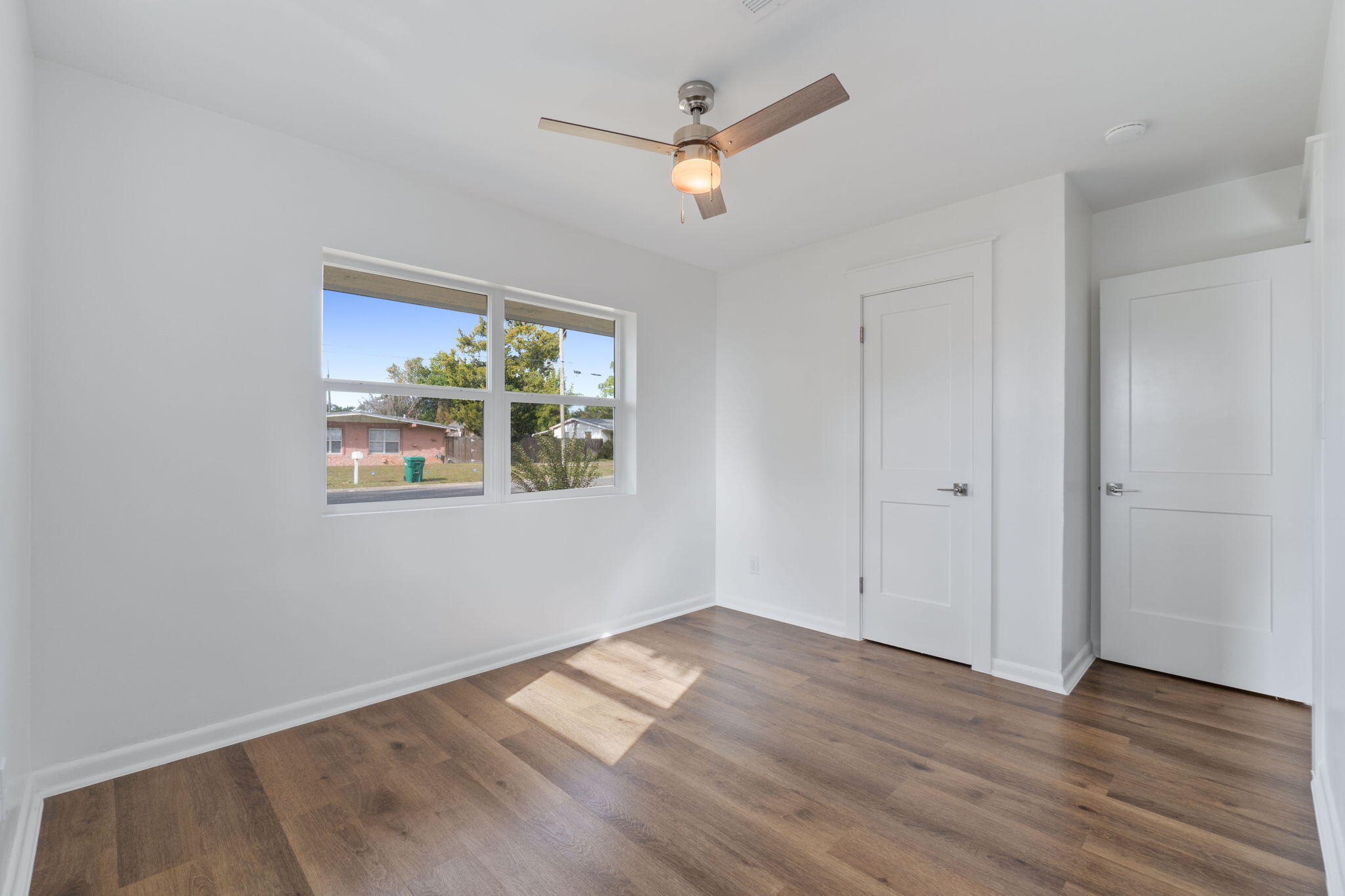 630 Shrewsbury Road Mary Esther, FL 32569 - Photo 24 of 39 an empty room with wooden floor and ceiling fan