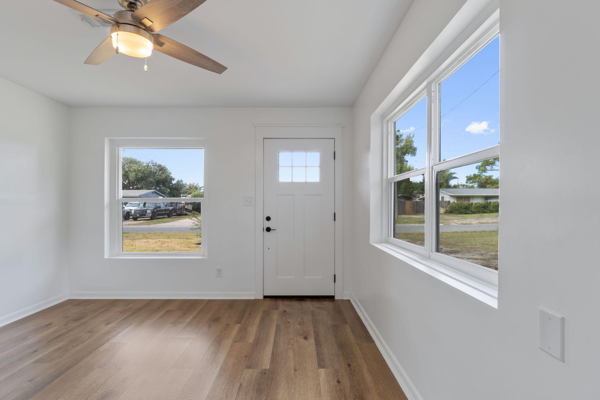 630 Shrewsbury Road Mary Esther, FL 32569 - Photo 4 of 39 a view of an empty room with a window and wooden floor