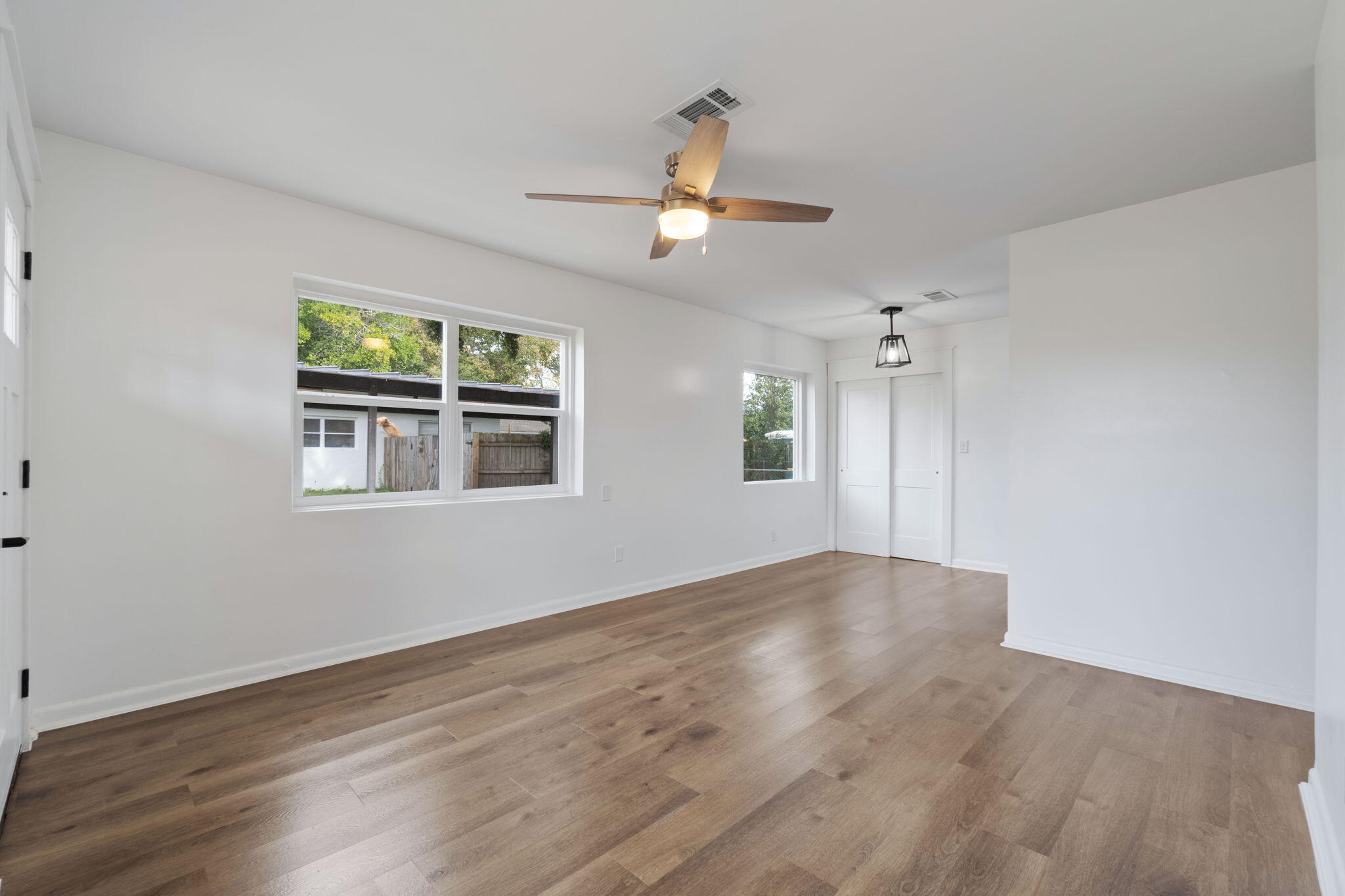 630 Shrewsbury Road Mary Esther, FL 32569 - Photo 6 of 39 a view of an empty room with wooden floor and a window