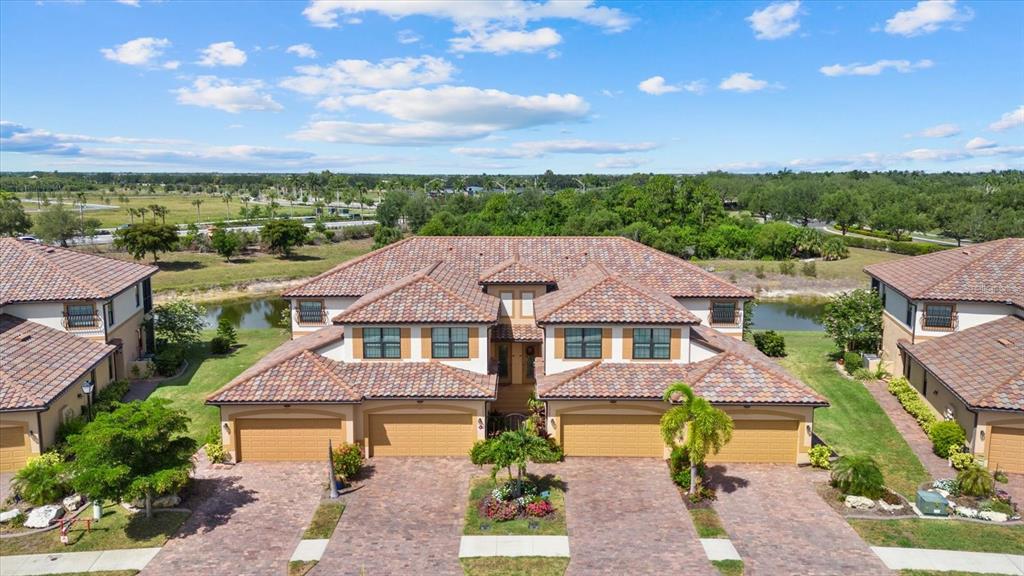 20080 Ragazza Circle, Unit 102 Venice, FL 34293 - Photo 7 of 49 an aerial view of a house with a garden and lake view