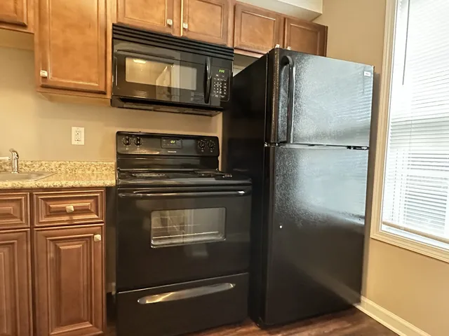 a kitchen with metallic refrigerator and microwave