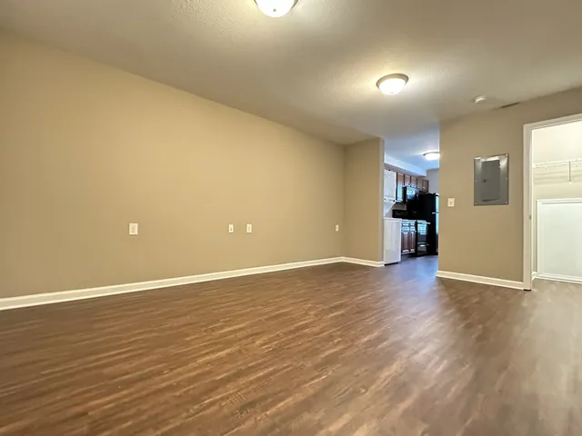 a view of an empty room with wooden floor