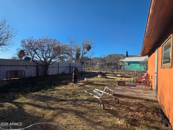 a backyard of a house with table and chairs