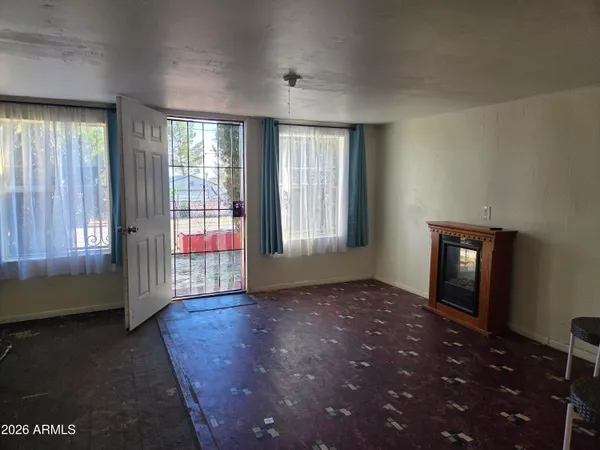 a view of an empty room with glass door