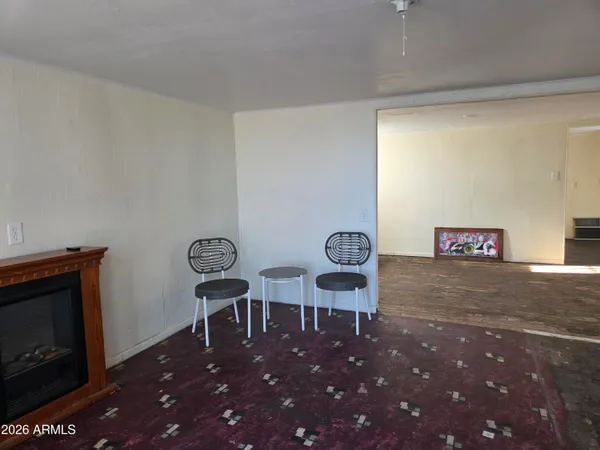 a view of a room with chairs and table