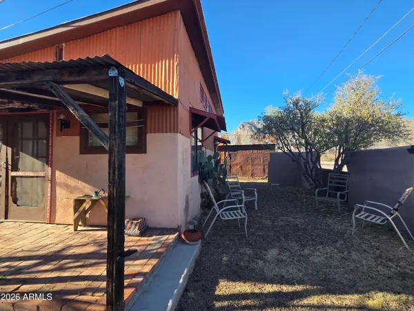 a view of a house with backyard and sitting area