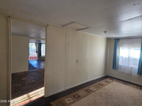 a view of a room with wooden floor and windows