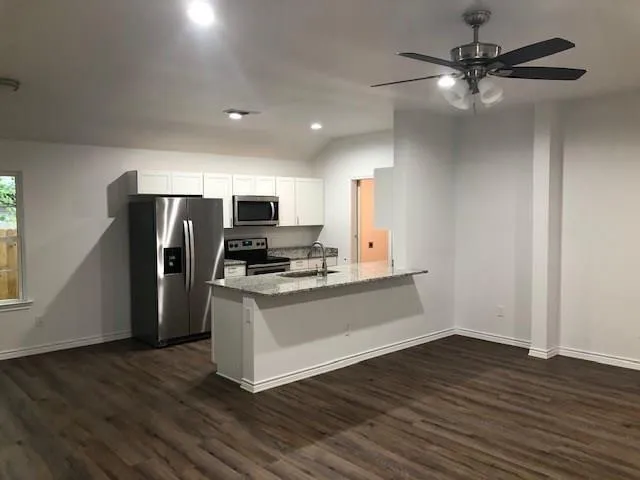 a kitchen with stainless steel appliances a refrigerator microwave and stove