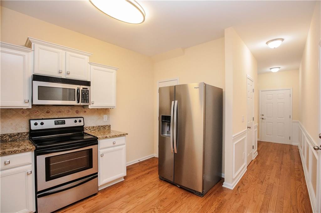 3801 Thayer Trace Duluth, GA 30096 - Photo 16 of 44 a kitchen with stainless steel appliances a refrigerator stove and microwave