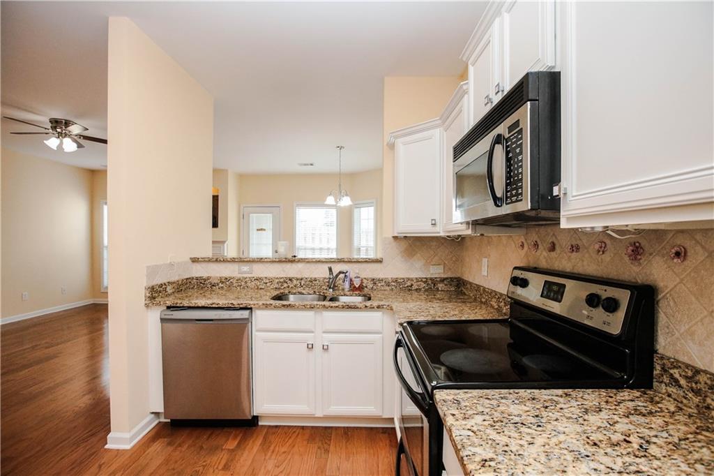 3801 Thayer Trace Duluth, GA 30096 - Photo 18 of 44 a kitchen with a stove a sink and a microwave
