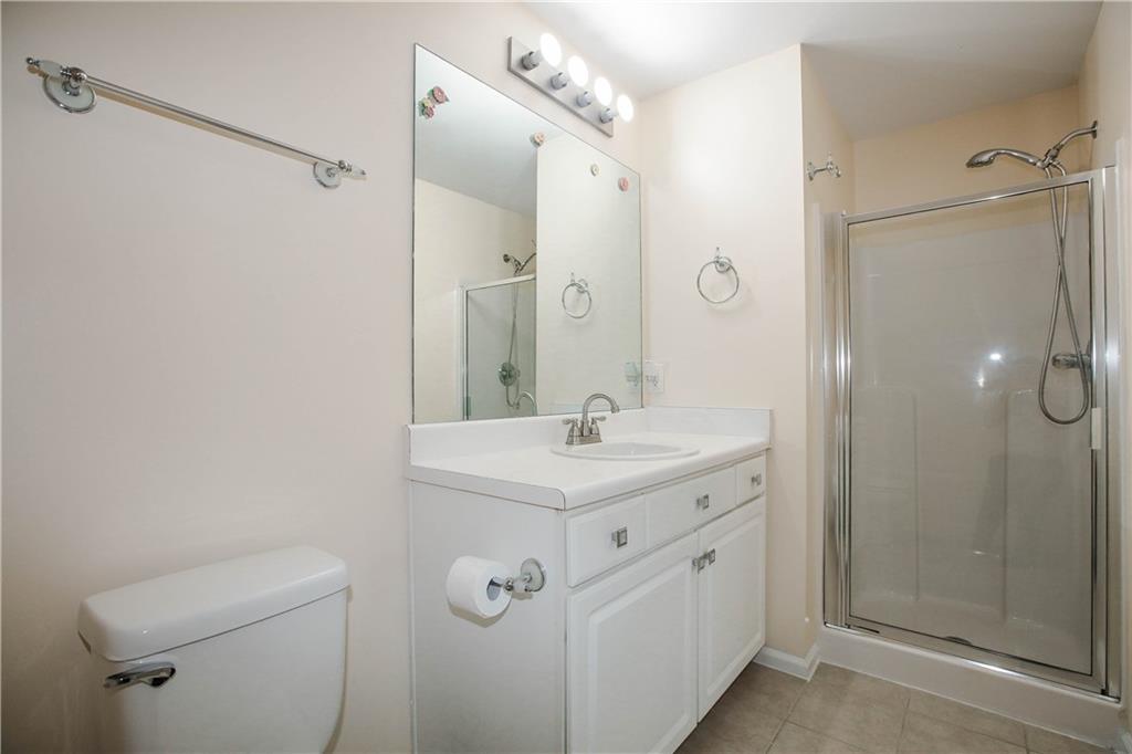 3801 Thayer Trace Duluth, GA 30096 - Photo 30 of 44 a bathroom with a granite countertop sink a mirror and a shower