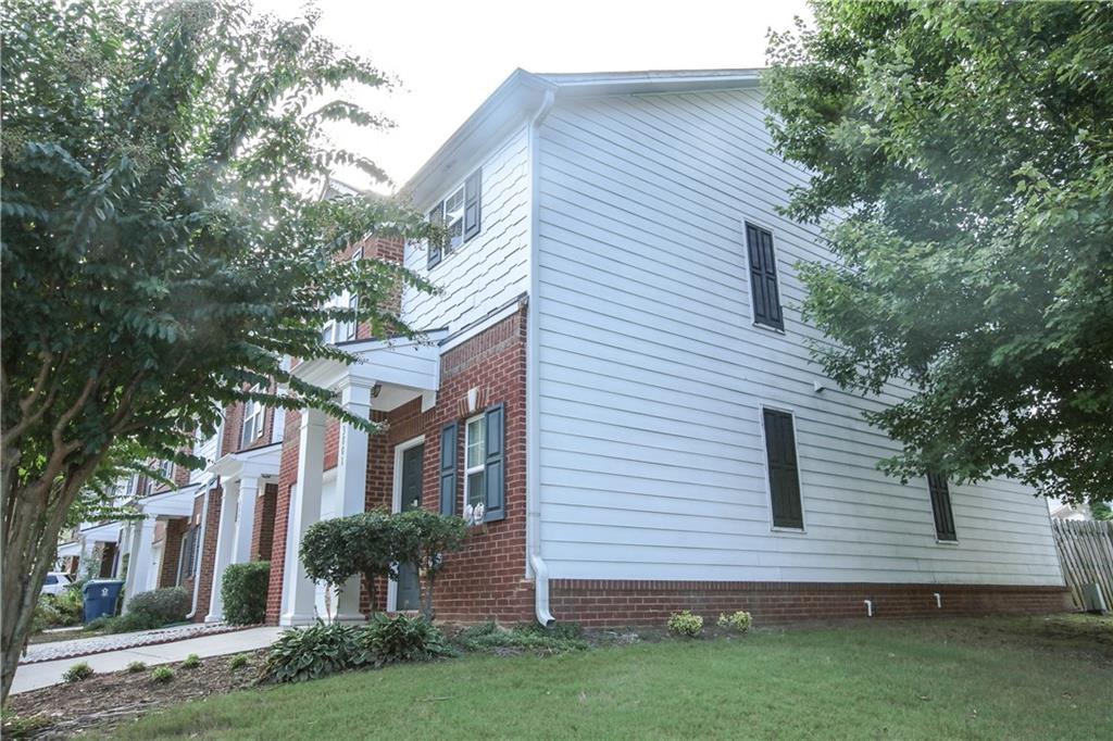 3801 Thayer Trace Duluth, GA 30096 - Photo 3 of 44 a view of a brick building next to a yard