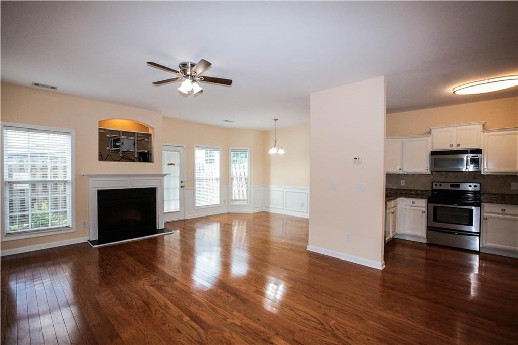 3801 Thayer Trace Duluth, GA 30096 - Photo 4 of 44 wooden floor fireplace and windows in an empty room