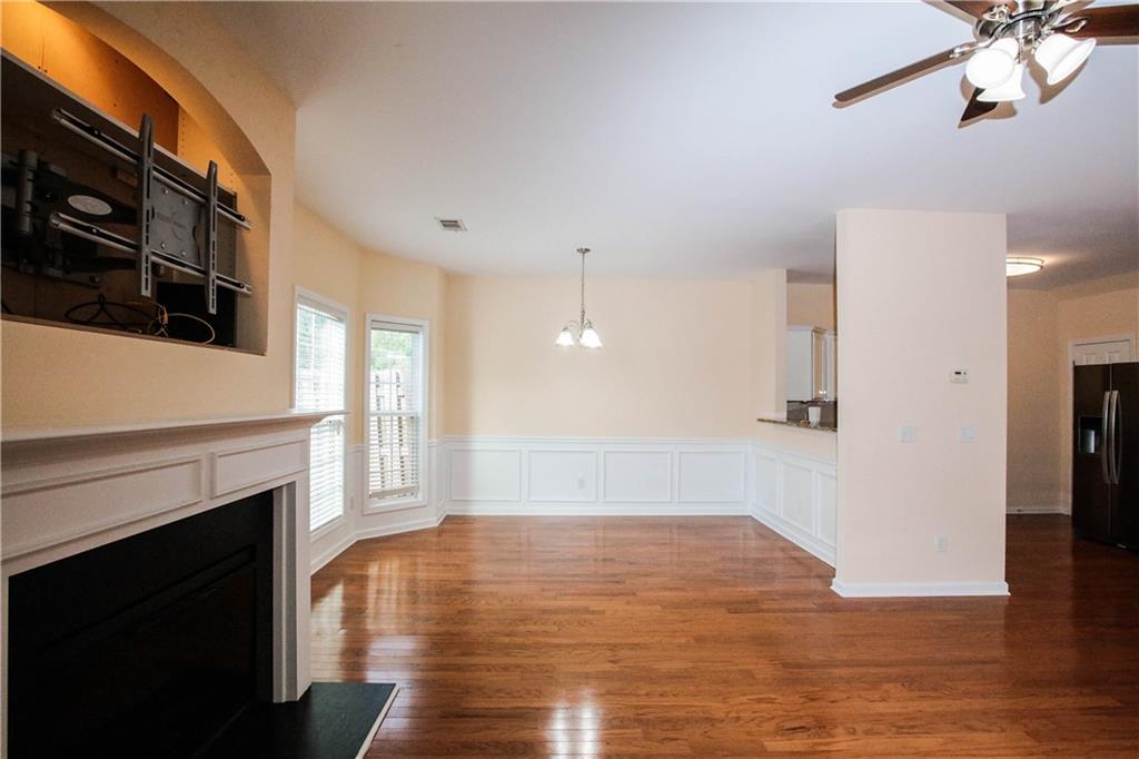 3801 Thayer Trace Duluth, GA 30096 - Photo 7 of 44 a view of empty room with wooden floor and fireplace