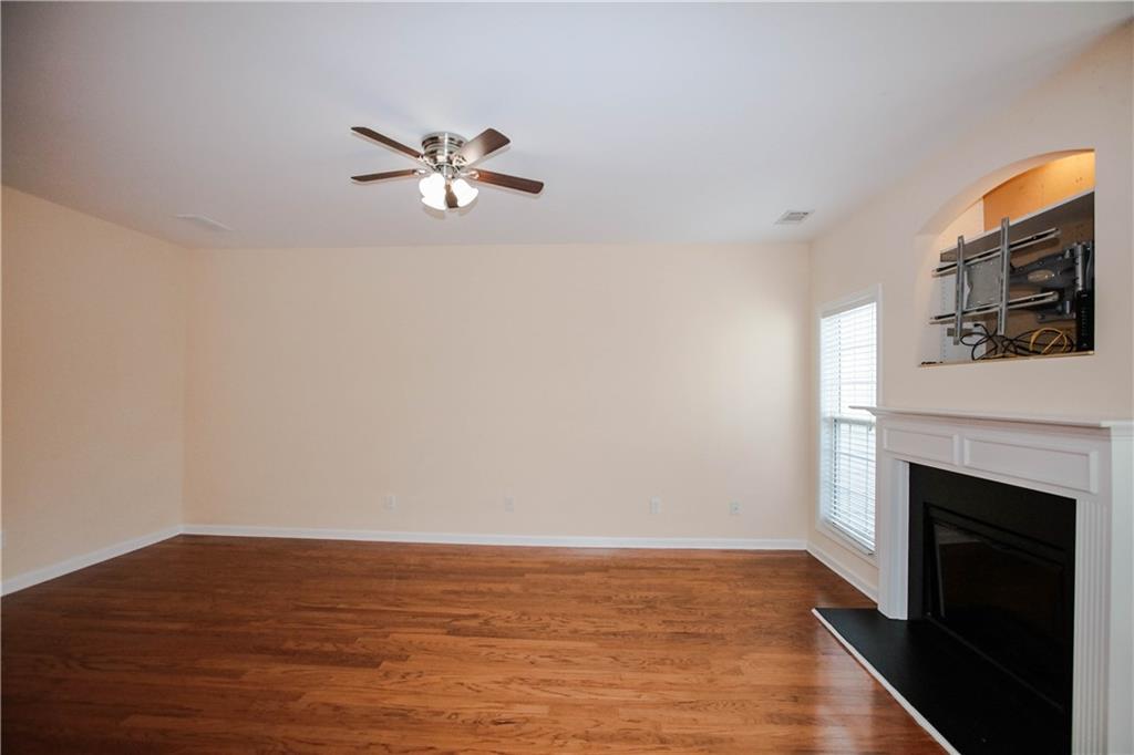 3801 Thayer Trace Duluth, GA 30096 - Photo 9 of 44 a view of empty room with wooden floor and fan